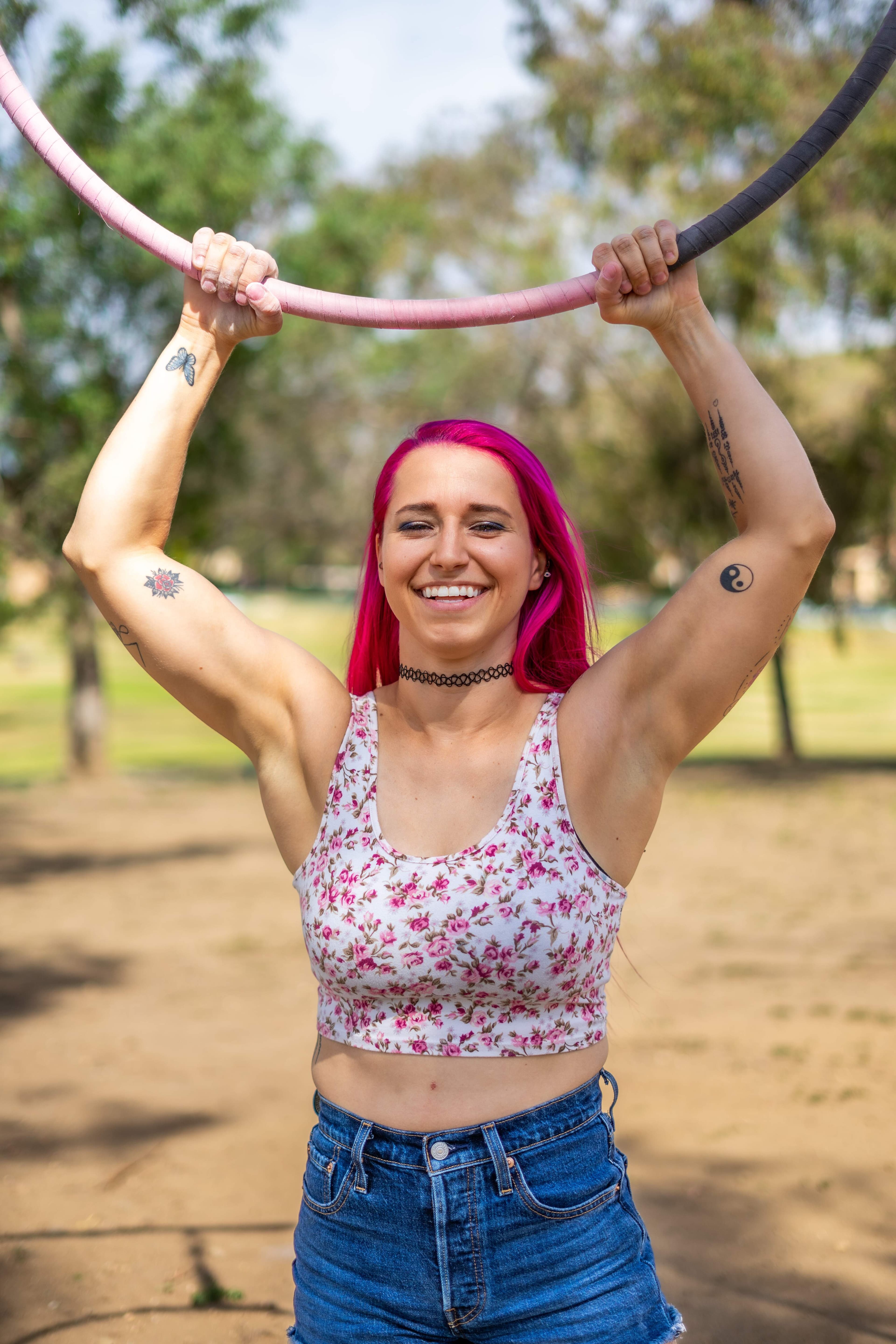 A girl smiling and holding a hula hoop